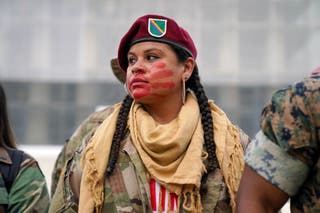 One of the demonstrators is seen with manual red face coating and red surfaces